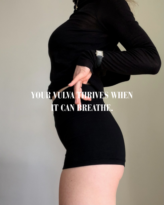 Woman wearing black BAUME natural fibre booty shorts made with TENCEL Lyocell