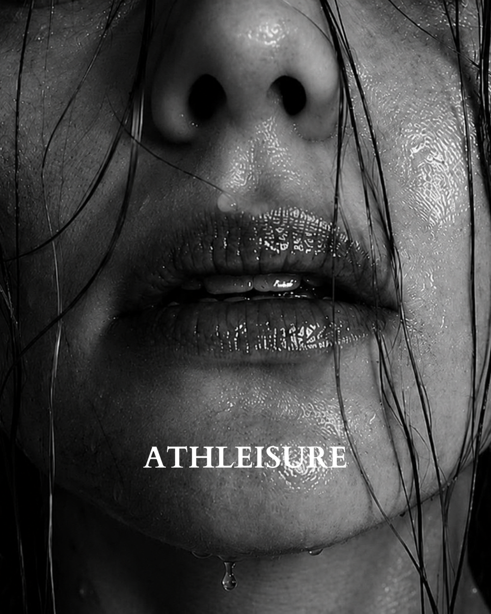 Black and white close-up of a person's lips and nose area with wet hair strands and a single dripping water droplet representing BAUME Athleisure