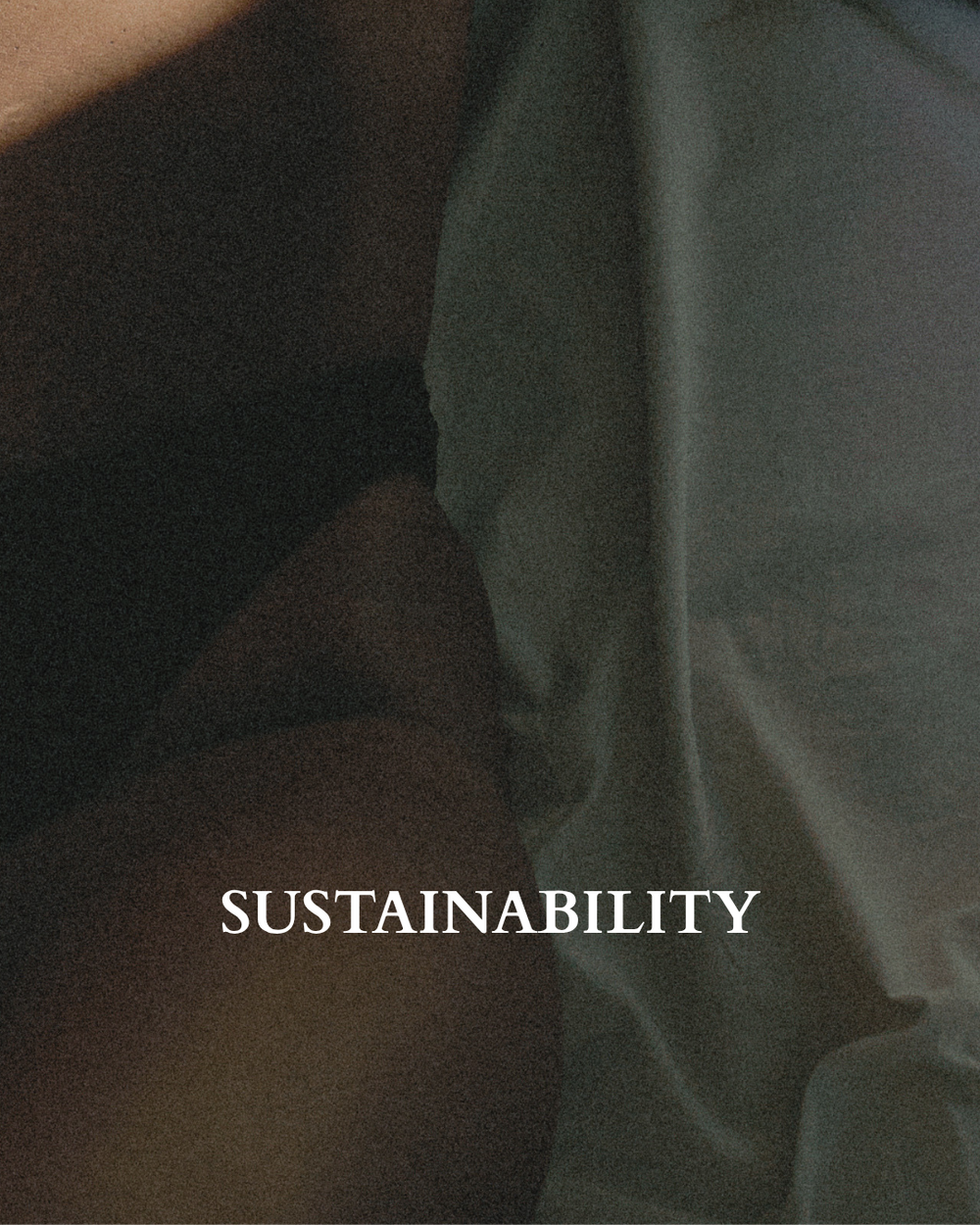 A close-up shot of a person lying in bed in Baume Essentials high-cut underwear with wrinkled gray-green bedding, featuring the word 'SUSTAINABILITY' printed in white serif text across the lower center.