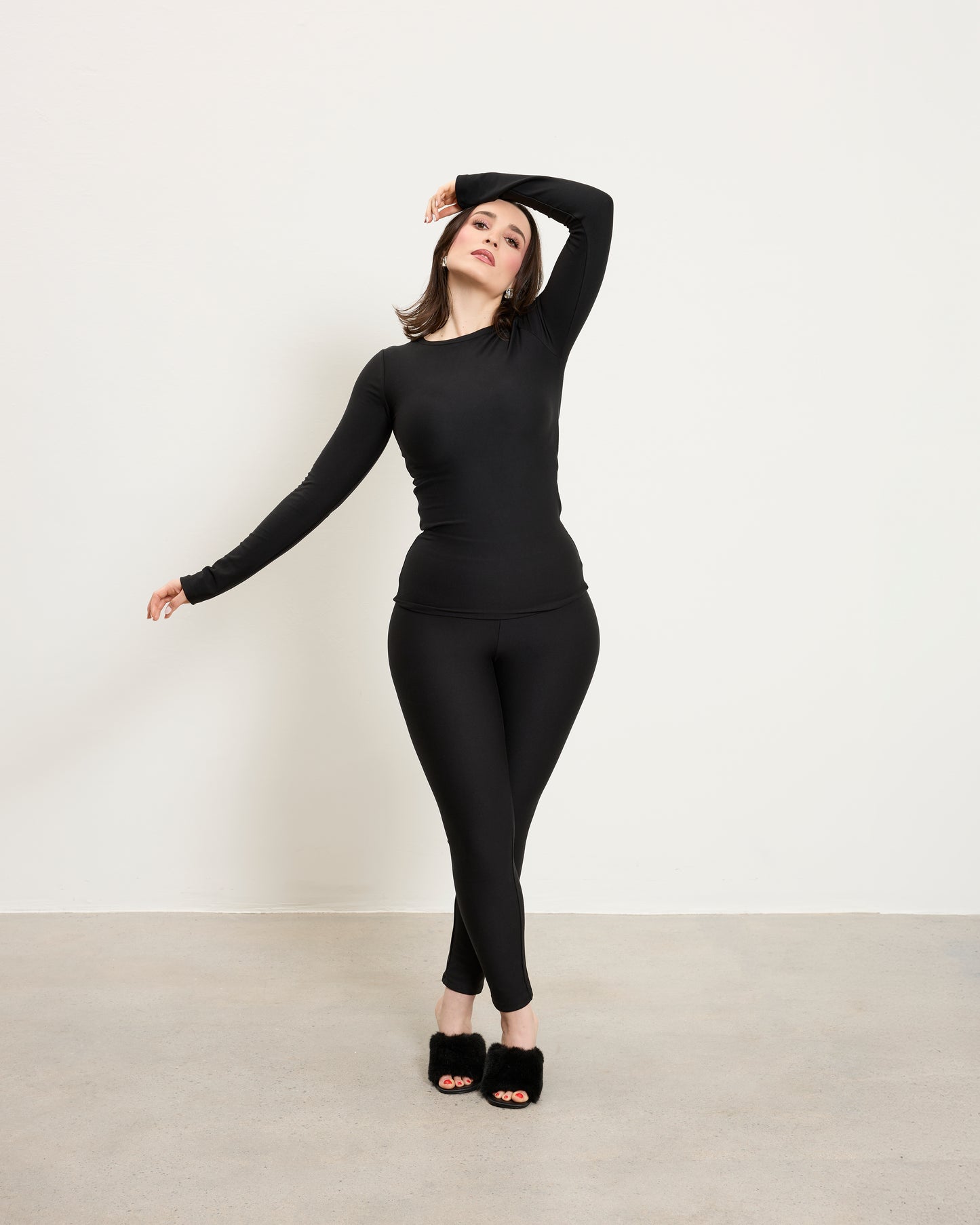 Model wearing Baume Essentials Atleisure long sleeve top and tights in TENCEL™ Lyocell designed for soft breathable everyday wear.
