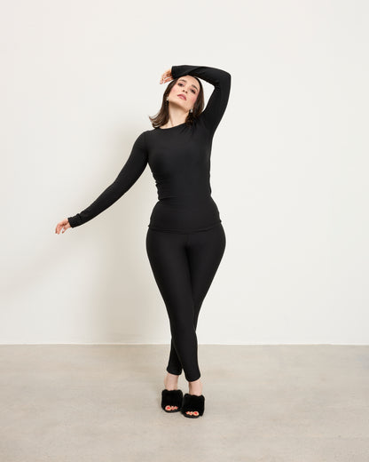 Model wearing Baume Essentials Atleisure long sleeve top and tights in TENCEL™ Lyocell designed for soft breathable everyday wear.
