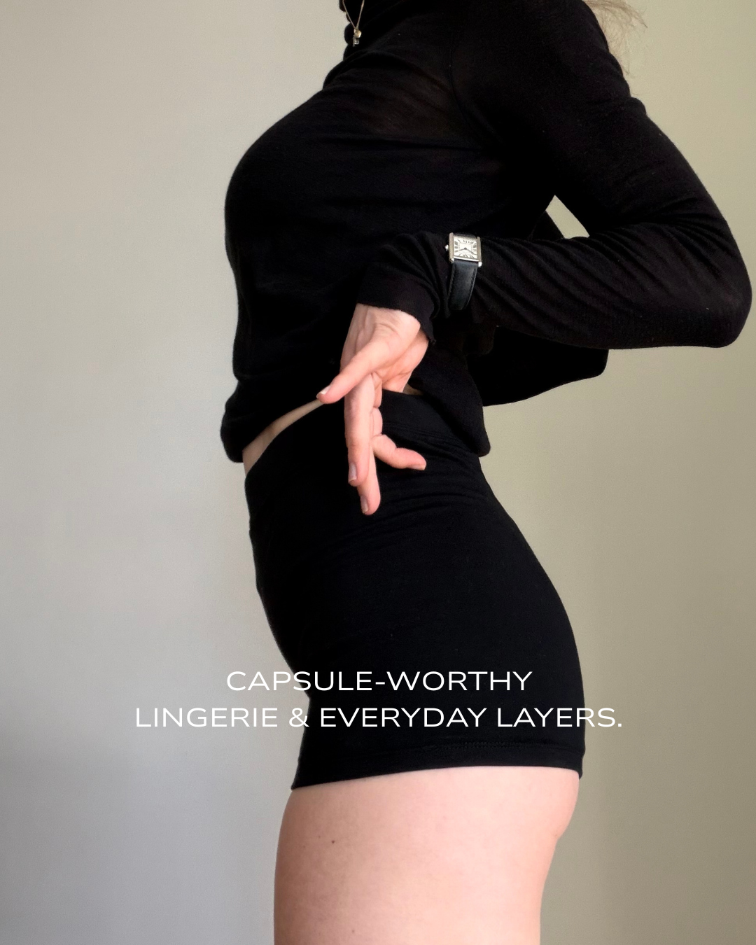 Woman wearing Baume Essential 03 Shorts with a sheer knitted sweater and luxury watch, styled as an elevated everyday look.