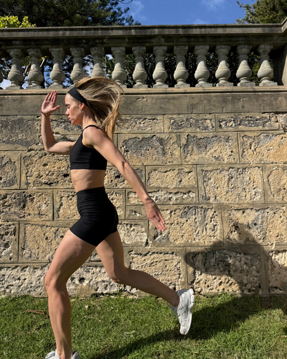 Woman outdoors in Baume Essentials Form Bralette and Form Shorts. Soft, lightweight athleisure made from breathable TENCEL™ Lyocell fibers with a timeless silhouette and comfortable fit.