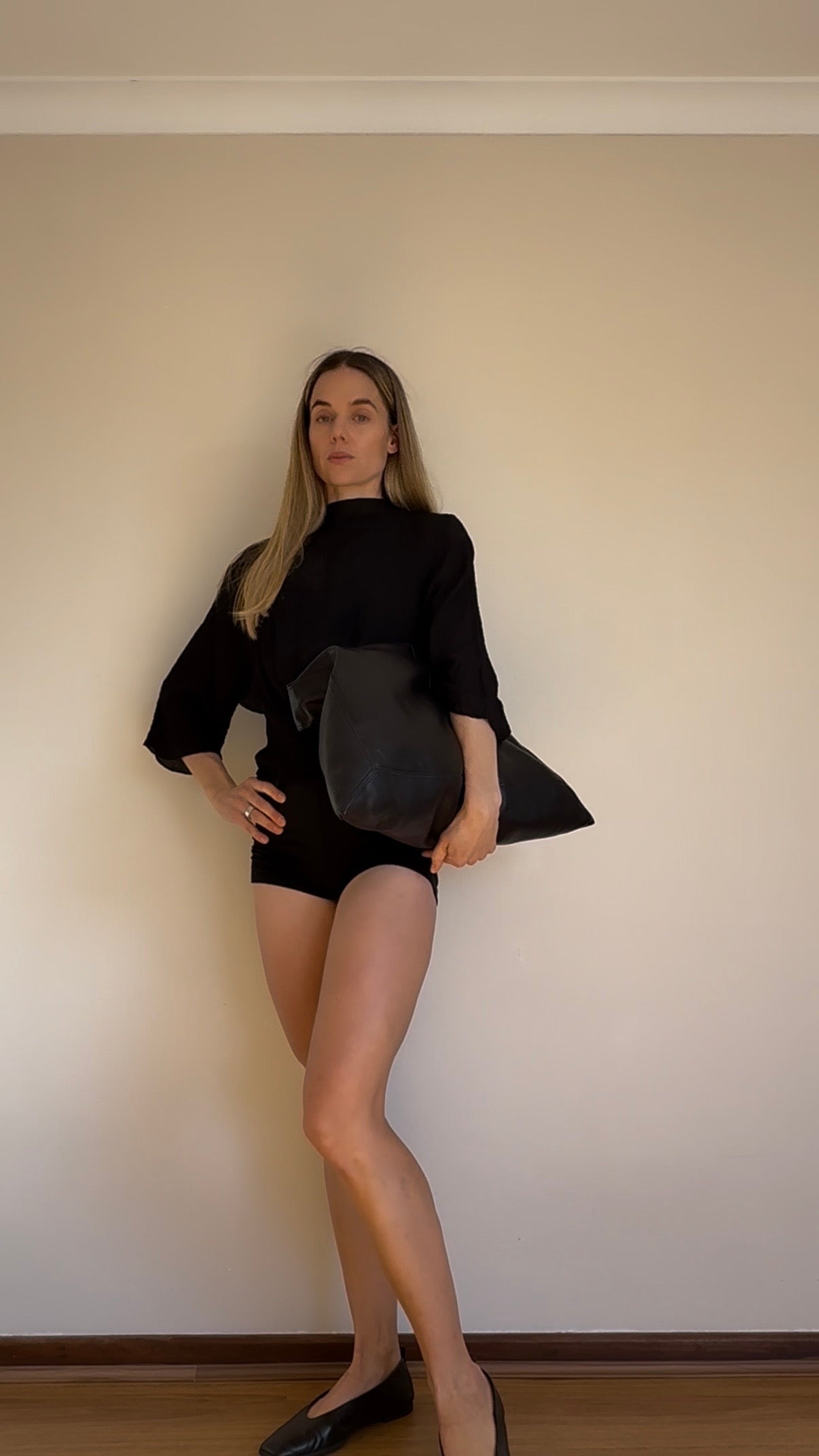 Co-founder Denise showcasing how to transform the versatile mii shorts from Baume Essentials to an everyday piece with a blouse and ballerina shoes. 